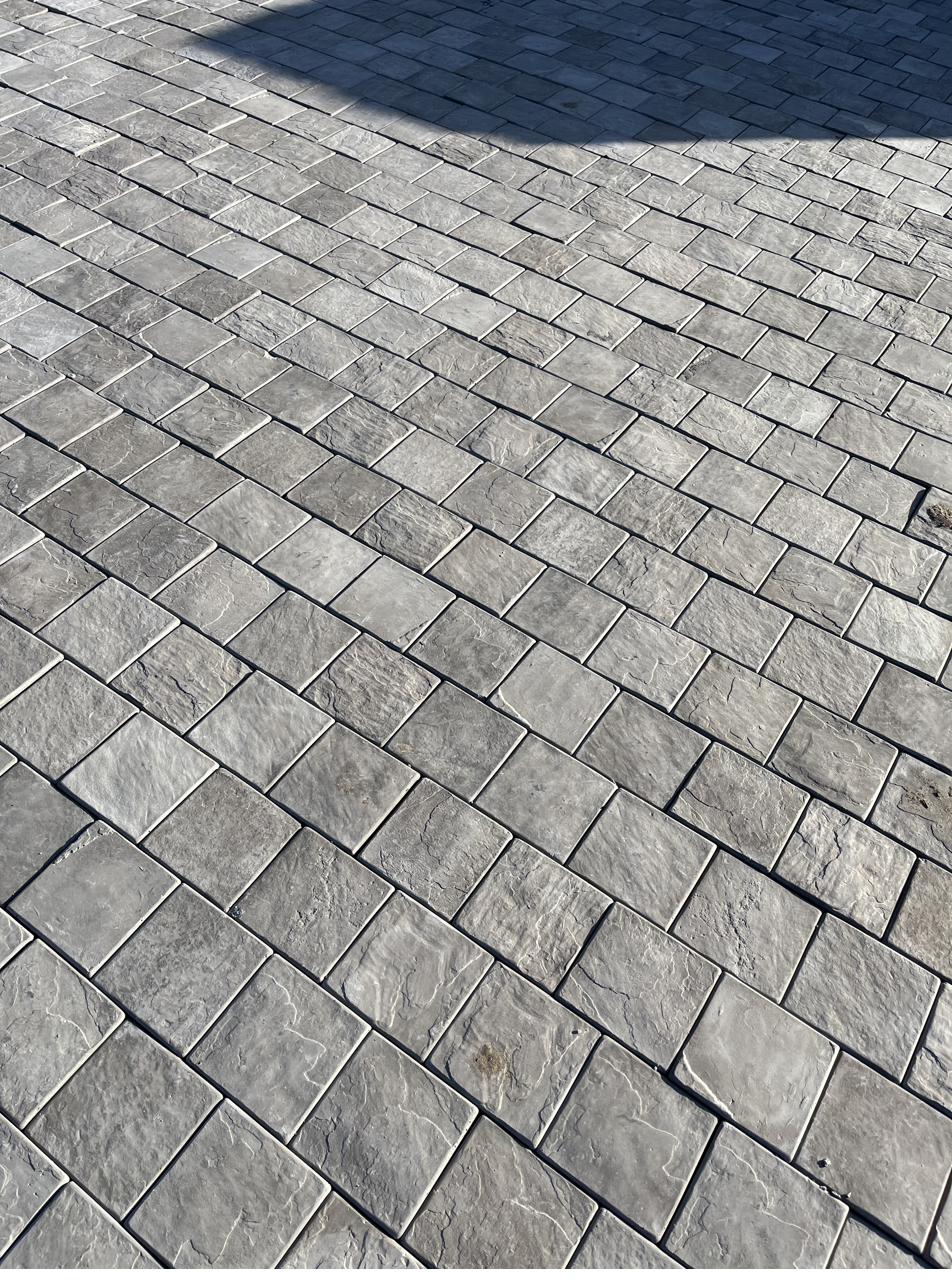 150 by 150 mm charcoal cobbles beside a lawn