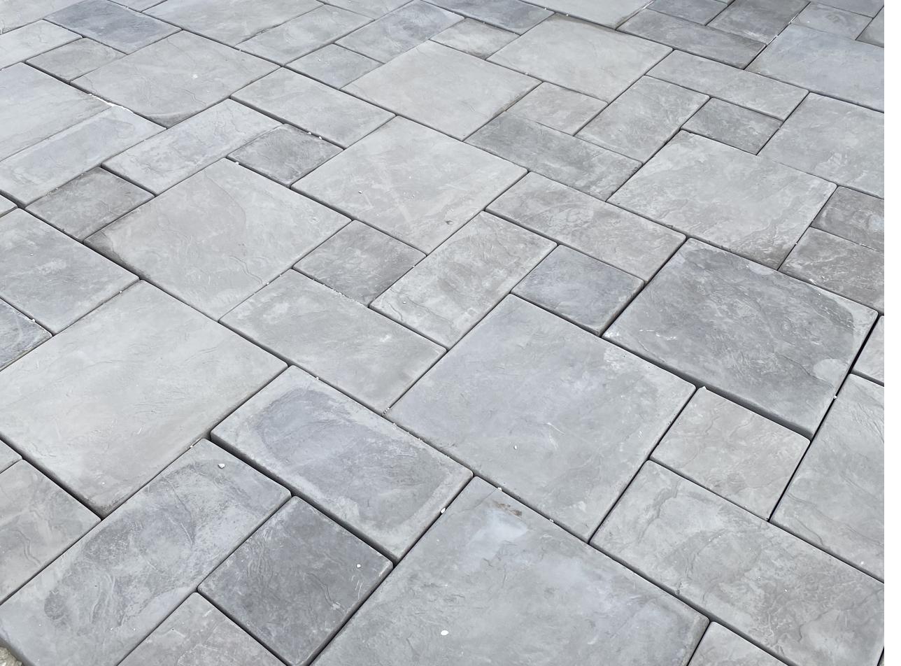 Grey SanStone pavers laid in a mixed-size pattern