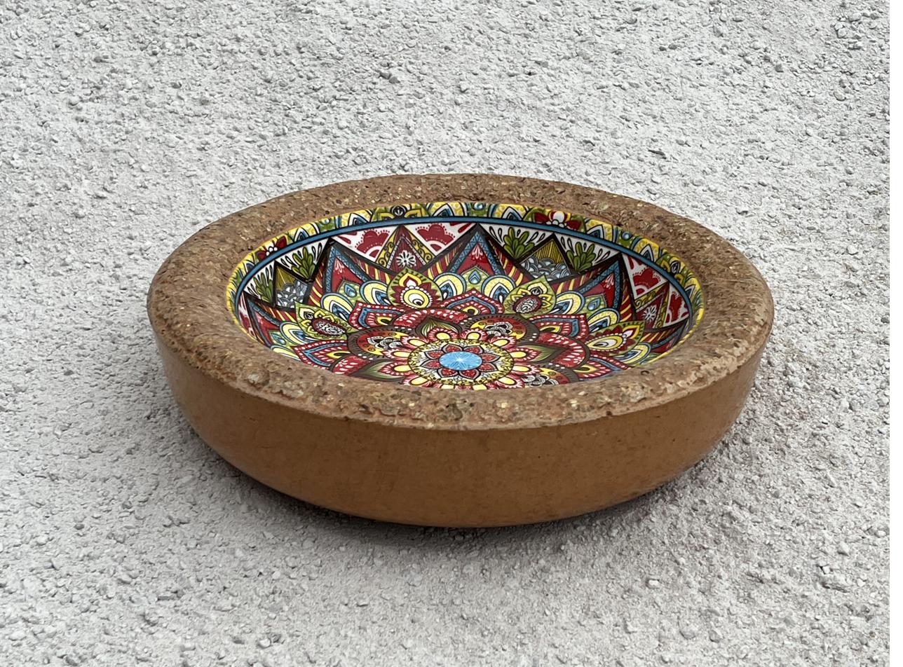 A hypertufta bird feeder with a patterned bowl