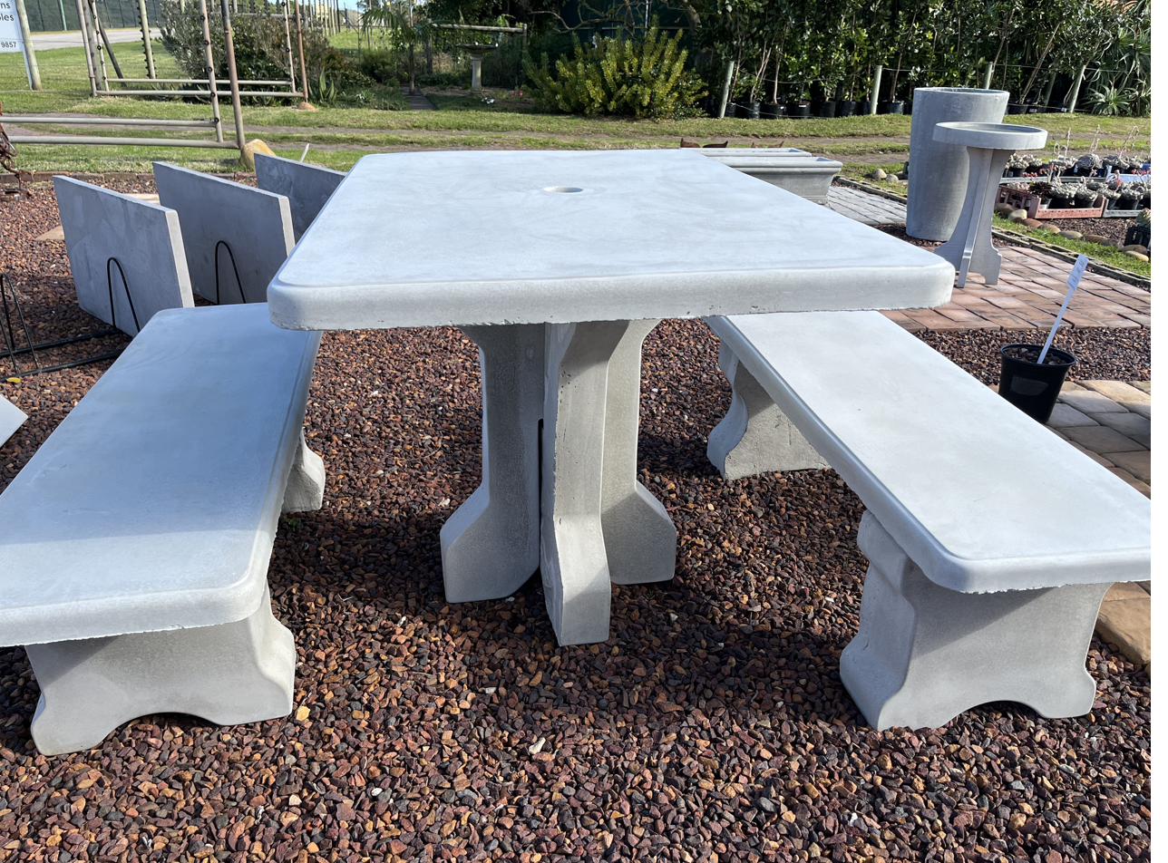 An oblong cement table with straight benches