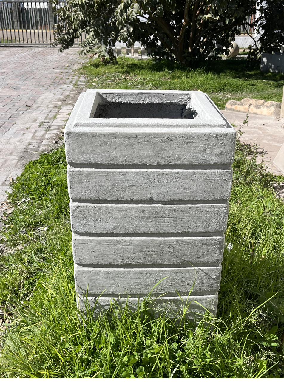 A ribbed square cement pot