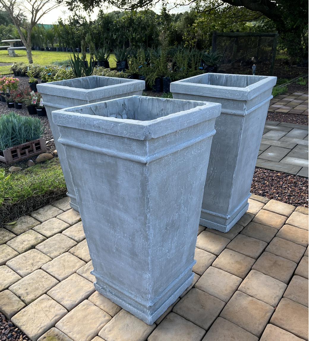 Three tall tapered cement Tuscan pots
