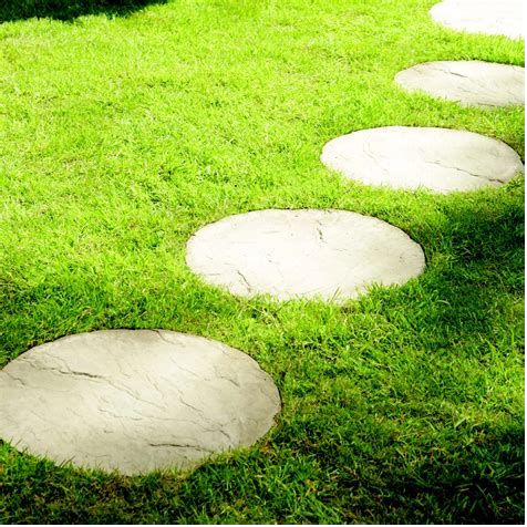 Round pavers as stepping stones across a lawn