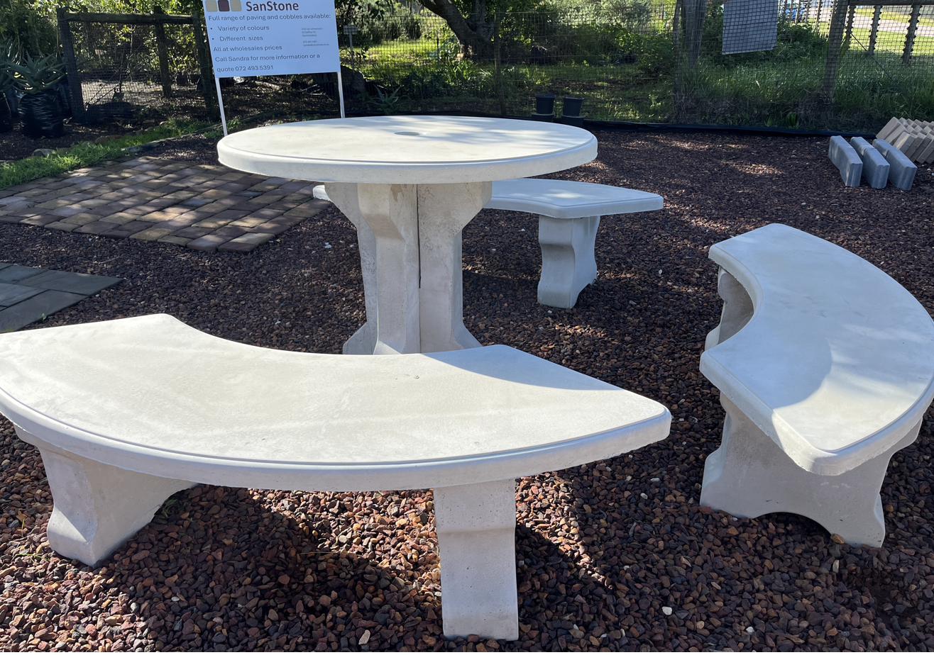 A round cement table with curved benches
