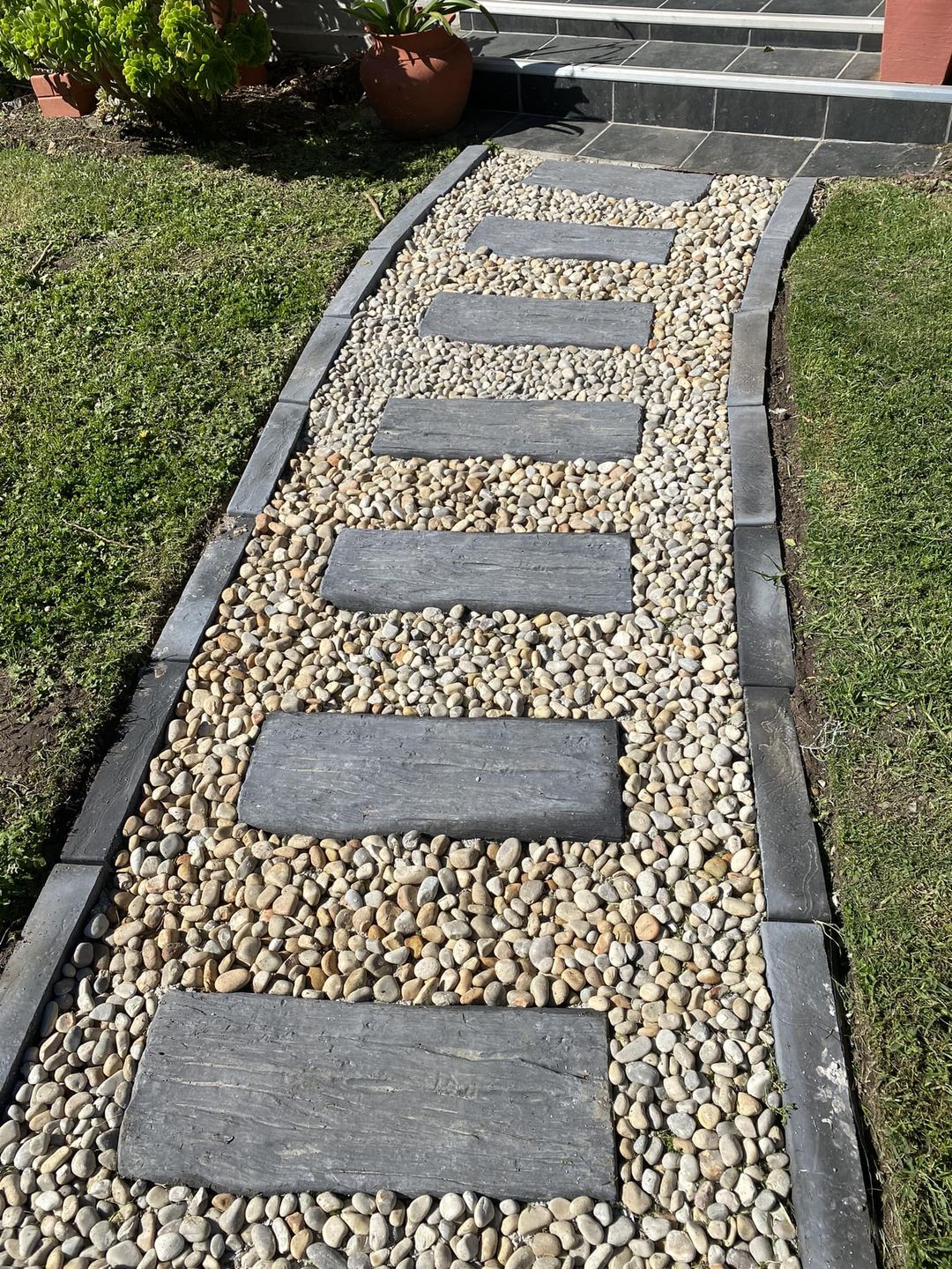 Sleeper-style pavers on a pebble path with edging